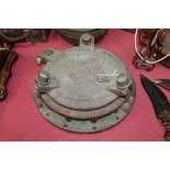 Antique brass porthole of large size, with hinged bolted cover,