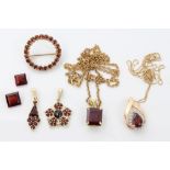 Group of garnet jewellery in gold setting - to include four pendants,