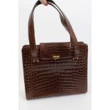 Kwanpen brown genuine crocodile skin handbag with gilt metal fastening