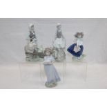 Four Lladro figures - to include girl with wheelbarrow and lamb, girl with rabbit,