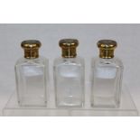 Three 1920s cut glass toilet jars with silver gilt mounts (London 1924),