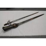 Indian Pata (gauntlet sword) with engraved and brass decoration, together with another Indian sword,