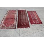 Tekke-style runner with two rows of sixteen medallions in geometric borders, 282cm x 87cm,