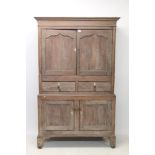George III limed oak livery cupboard with concave cornice and enclosed by pair of arched panelled