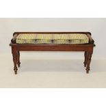 Victorian pine window seat with squab cushion flanked by roundel ends, raised on turned supports,