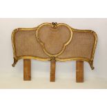 Continental gilt gesso and carved bed headboard of serpentine outline,