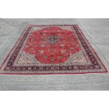 Sarough carpet, red field with broad cream spandrels and multiple scrolling foliate borders,
