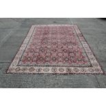 Mahal carpet with allover flower-head field within main cream foliate border,