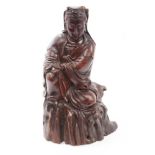 Antique Chinese carved hardwood figure of Guanyin in contemplative pose, kneeling on rocky plinth,