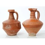 Two Ancient Roman Samian ware red pottery ewers with loop handles - one with thumbed decoration,