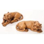 Pair of Japanese carved boxwood figures of tigers, each finely carved in recumbent pose,