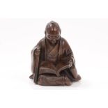 Late 19th century Japanese bronze seated figure of a man reading, 6.