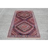 Iranian rug, having two serrated medallions with radiating bands in geometric borders,