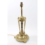 Good quality brass table lamp with reeded pilasters and leaf swags, on scroll feet,