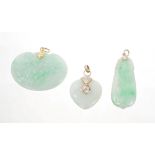 Three Chinese carved green jade / hardstone pendants