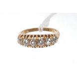 Victorian diamond six stone ring with six old cut diamonds in gold claw setting, on plain shank.