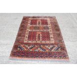 Tribal rug, the brick-red ground with compartmentalised geometric devices,