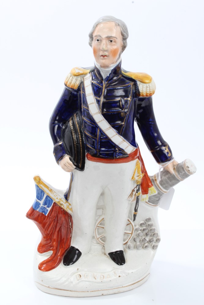 Victorian Staffordshire figure of Admiral Dundas in uniform, with cannon and flag supports,