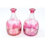 Pair late 19th century ruby glass overlaid magnum decanters with slice and vine cut decoration (no