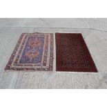 Persian rug with two conjoined medallions within scattered animal motifs and geometric borders,