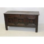 17th century carved oak coffer, the broad solid hinged top enclosing interior with candle box,