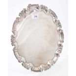 Victorian silver salver of circular form with piecrust border and scrolling edge,