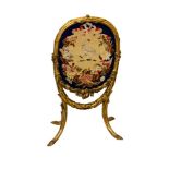 19th century French carved gilt gesso fire screen with embroidered oval armorial within ribbon and