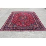 Meshed carpet, the crimson field with central medallion within main lotus flower border,