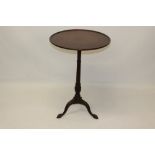 George III-style mahogany wine table with solid circular top,