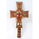 A wooden processional cross with inset bead decoration and gilt and red paintwork