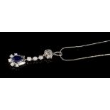 Diamond and sapphire pendant with a pear-shape blue sapphire surrounded by five brilliant cut