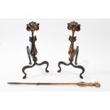 Pair of Art Nouveau copper and steel fire dogs, with stylised beaten copper floral uprights,