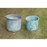 Two graduated copper vessels, each of riveted form, with everted rim and flanking handles,