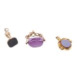 Three fobs / seals - to include amethyst coloured revolving stone,