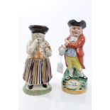 Early 19th century Pratt-type Toby jug of a woman taking snuff, with floral and striped dress,