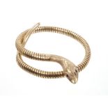 Gold (9ct) snake bangle with garnet eyes and coiled gold body (Birmingham 1973) CONDITION