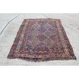 Persian rug with two rows of serrated medallions on navy ground within multiple geometric borders,