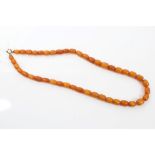 Old amber bead necklace with a string of graduated amber beads, approximately 57cm long,