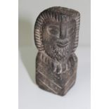 Antique tribal blackstone carving of triangular cross-section form, depicting a bearded man,