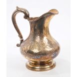 Victorian silver cream jug of baluster form, with chased floral decoration,