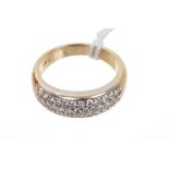 Diamond set band ring with pavé set brilliant cut diamonds in yellow metal setting, engraved '18ct'.