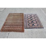 Eastern rug with rows of conjoined medallions against a pale brown ground in multiple borders,