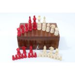 19th century 'Lund' pattern ivory and stained ivory chess set, the king 7.