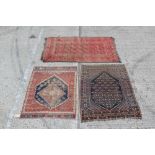 Tekke-style rug with three rows of eight octagonal medallions on brick-red ground in geometric