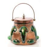 Art Nouveau iridescent green glass and copper mounted Cobral ware biscuit barrel and cover of