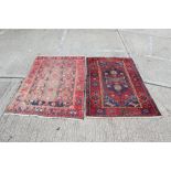 Heriz-style rug with central serrated medallion against blood-red field within conforming borders,