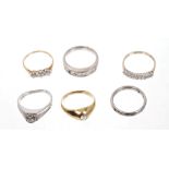 Six gold and gem set rings - to include diamond three stone ring,