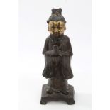 Chinese Qing period bronze and parcel gilt figure of a bearded man in robes, holding a tablet, 23.