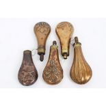 Group of five 19th century copper and brass powder flasks with embossed decoration