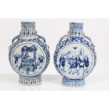 Two 19th century Chinese export blue and white moon flasks painted with domestic scenes,